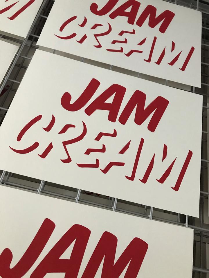 A view of the drying rack in the screenprinting studio, show multiple A4 Cream first prints, drying.