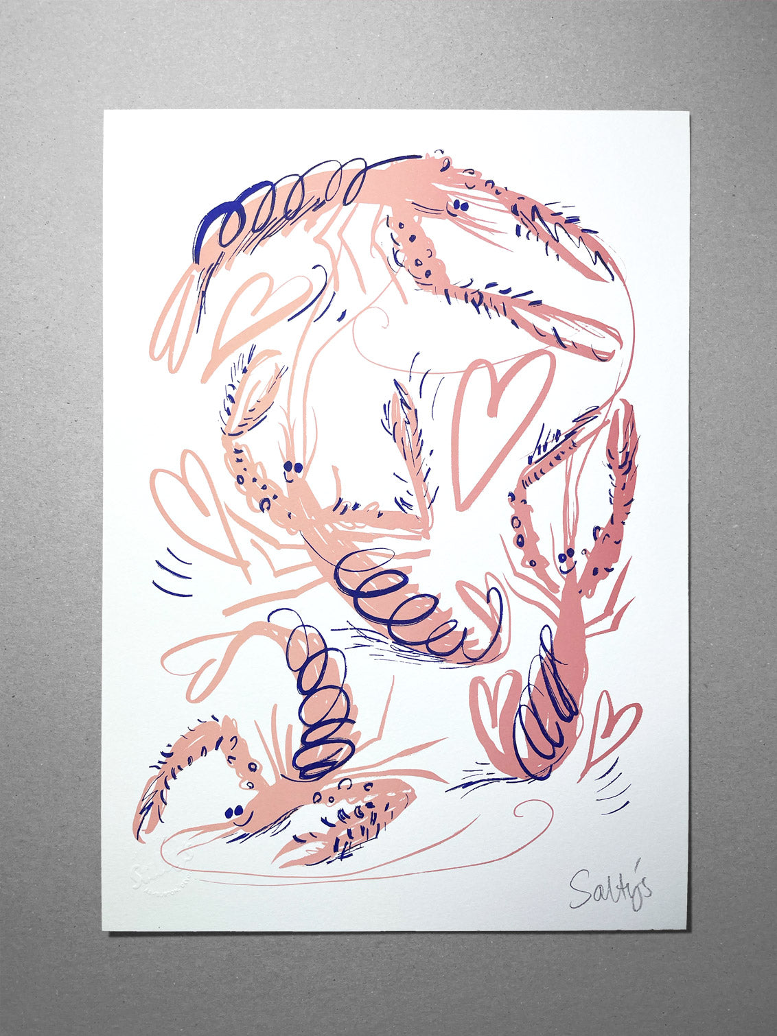 Flat lay of a few sheets of paper showing our pink cartoon langoustine, flung into a frenzied swirl, with hearts and scribbles making this a joyful scene. These are creenprinted in pink with blue accents on a grey recycled card background.