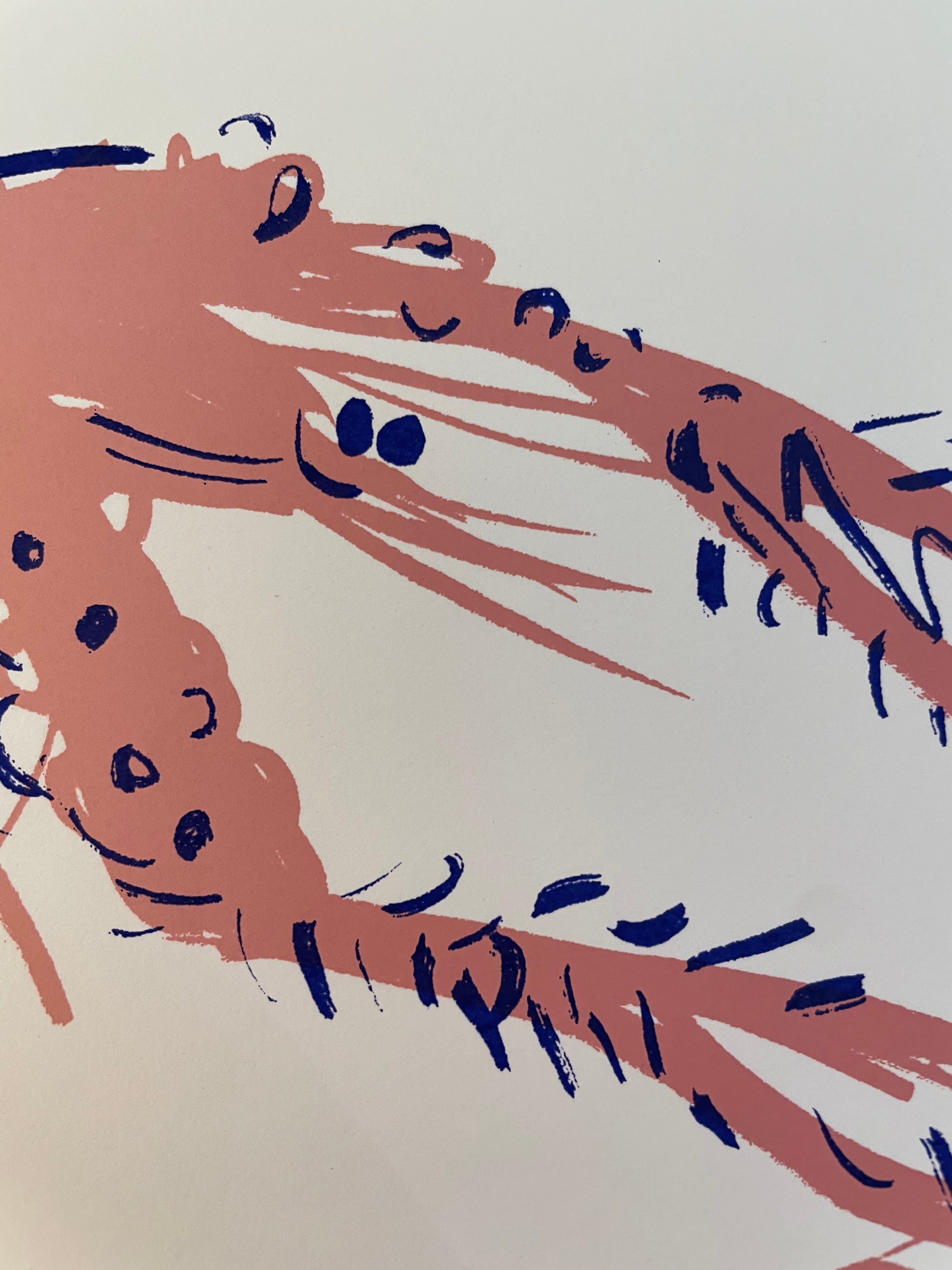 Close up of a screenprinted langoustine’s face, salmon pink body and blue eyes, smiley face and bits. 