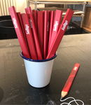 Red carpenters pencils in a Falconware tumbler pot, on a desk in the Salty’s Studio