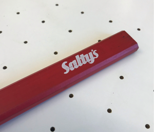 The end of a Salty’s pencil, at an angle. red carpenters pencil on a white background